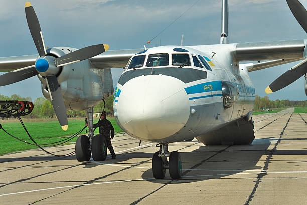 Ukrainian Air Force An-26 Vasilkov, Ukraine - April 24, 2012: Ukrainian Air Force An-26 cargo plane being prepared for the engine start antonov an 26 stock pictures, royalty-free photos & images