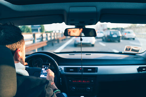 istock Heavy traffic, man checks smartphone 512978417
