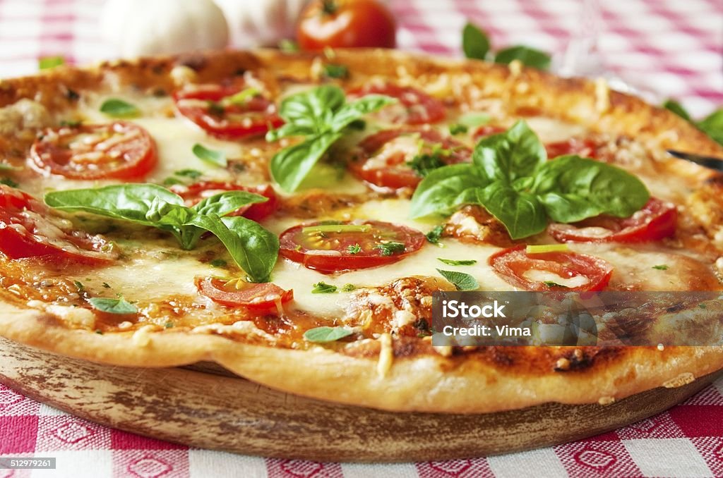 Italian Pizza Margherita Italian Pizza Margherita with mozzarella, garlic and tomatoes Baked Stock Photo