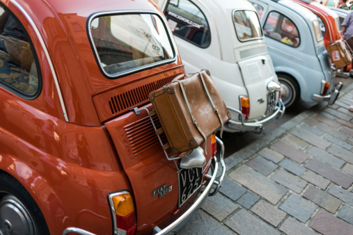 Gattinara, Italy - September 7, 2014: Vintage Italian cars Fiat 500 parked in the streets of Gattinara, Italy, during a festival.