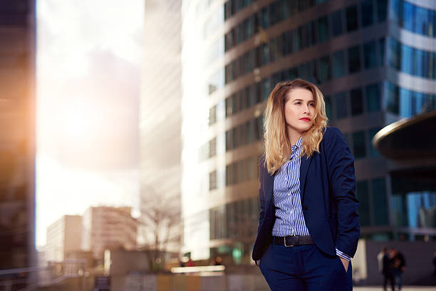 istock cool business woman holding hands in pockets 512980530
