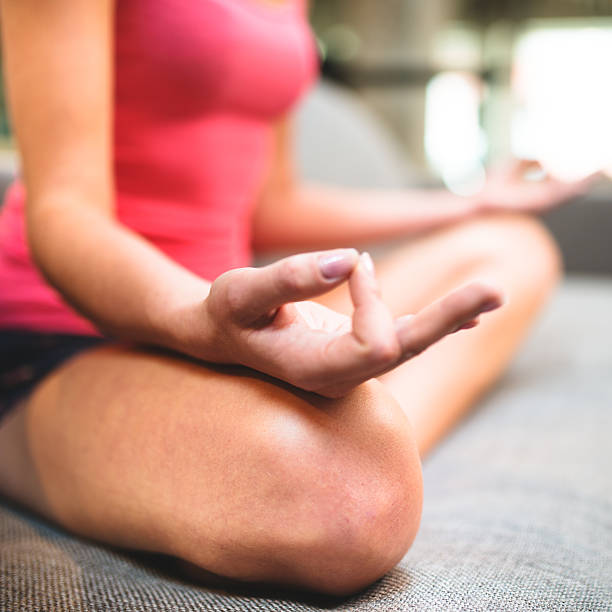 istock woman doing yoga on the couch 512981157