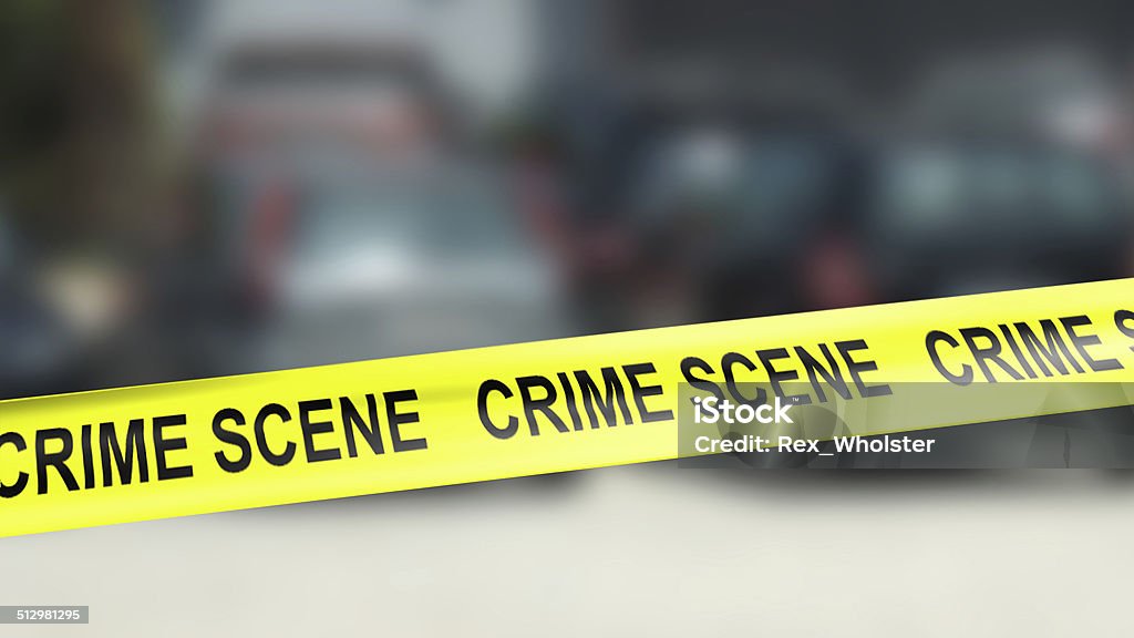 "Crime Scene" tape Crime scene tape with out-of-focus background suggesting location where crime and subsequent investigation occured Courthouse Stock Photo