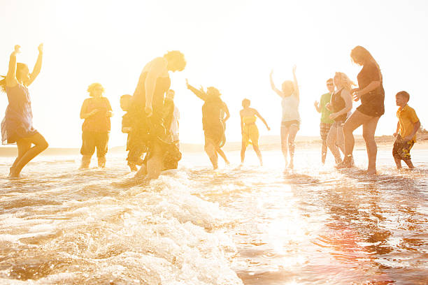 istock Group of people running on the beach 512981567