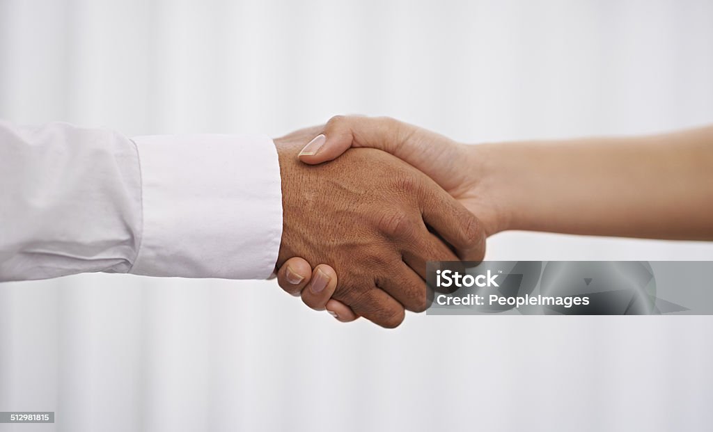 They've come to an agreement Cropped shot of two hands joining for a hand shake Achievement Stock Photo