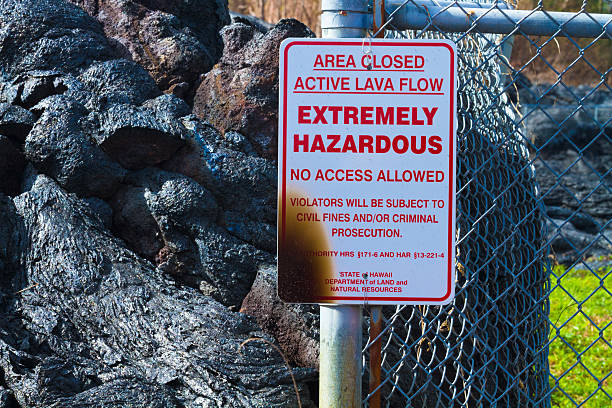 Destroyed sign Warning sign destroyed by advancing lava in the town of Pahoa, Big Island, Hawaii pele stock pictures, royalty-free photos & images