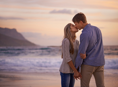 Shot of a young couple enjoying a romantic kiss on the beach at sunsethttp://195.154.178.81/DATA/shoots/ic_783786.jpg