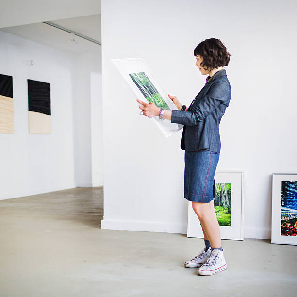 Gallery Owner Inspecting Picture
