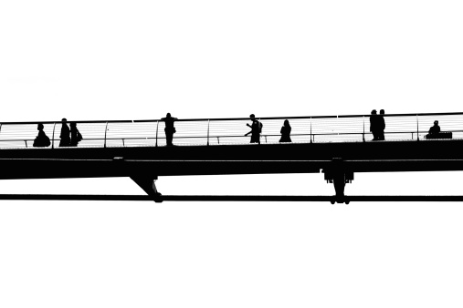 Silhouette of people walking on the Millennium Bridge in London, United Kingdom
