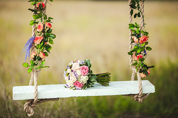 Wedding bouquet of peonies lying on white bench swing decorated stock photo