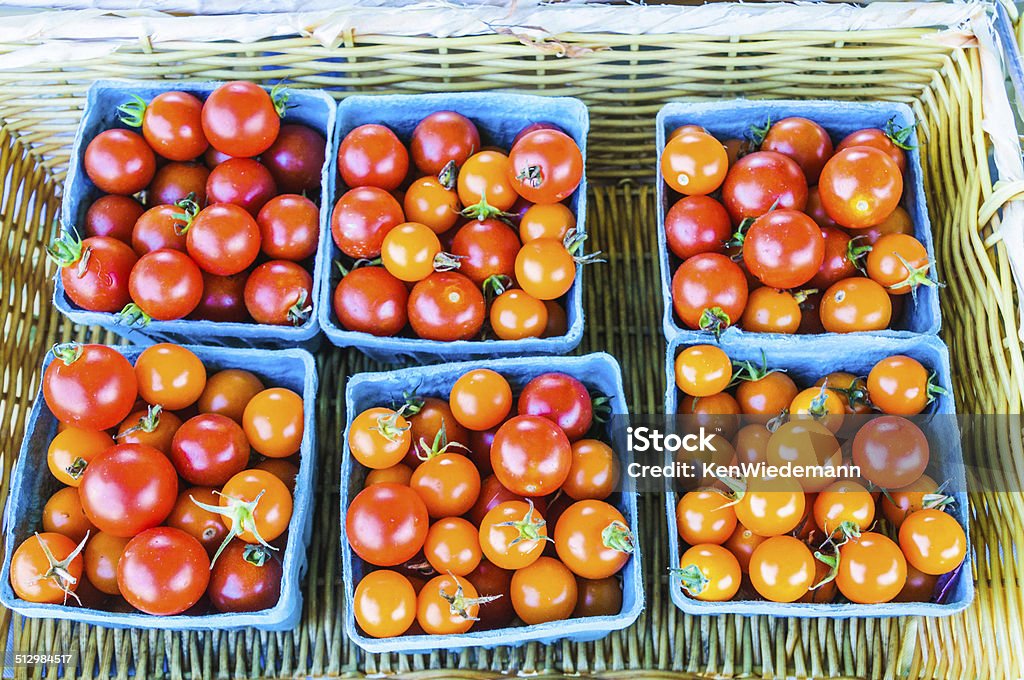 Baskets of Tomatoes Blue paper pint baskets of cherry tomatoes at a Connecticut farmers market. Basket Stock Photo