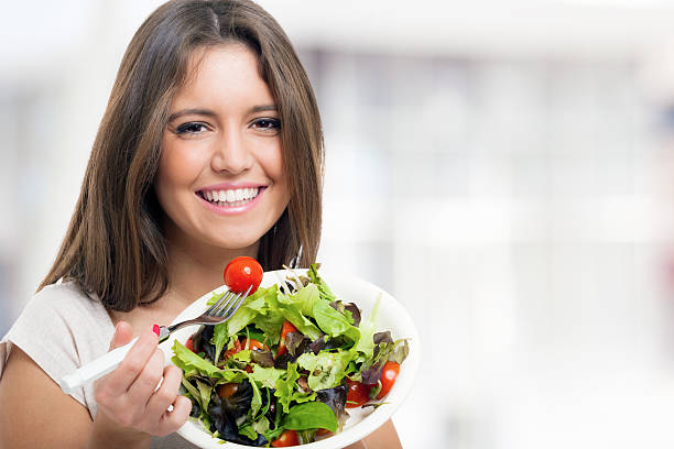 istock Woman eating a healthy salad 512984567