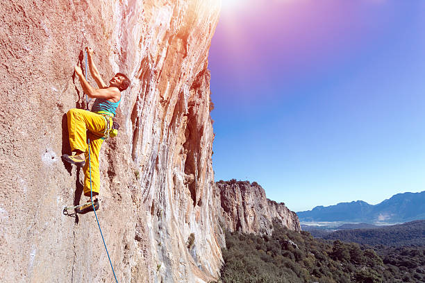 istock Mature male extreme Climber moving up on rocky Wall 512985026