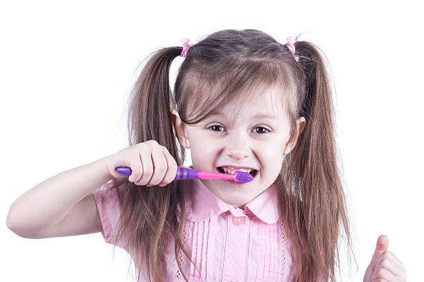 istock fun child cleaning teeth isolated on white background 512985082