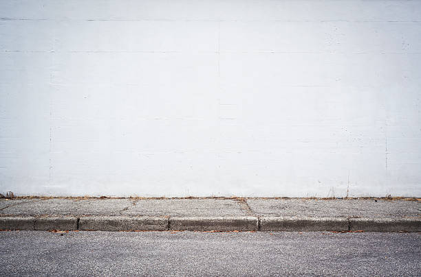 istock Asphalt Street And White Wall 512986267