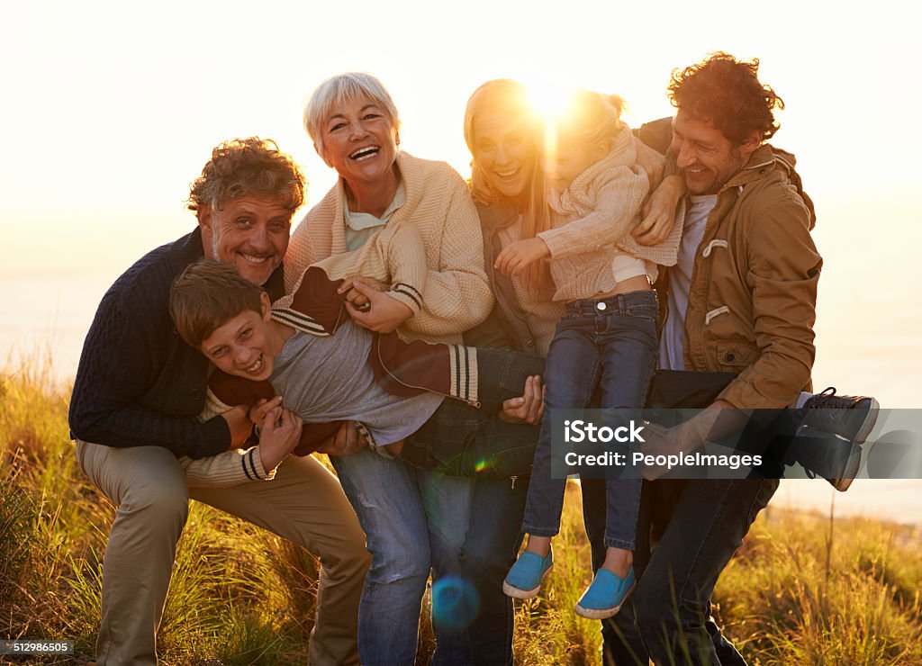 Holding up the family line Shot of a happy family banding together to hold up the children Grandfather Stock Photo