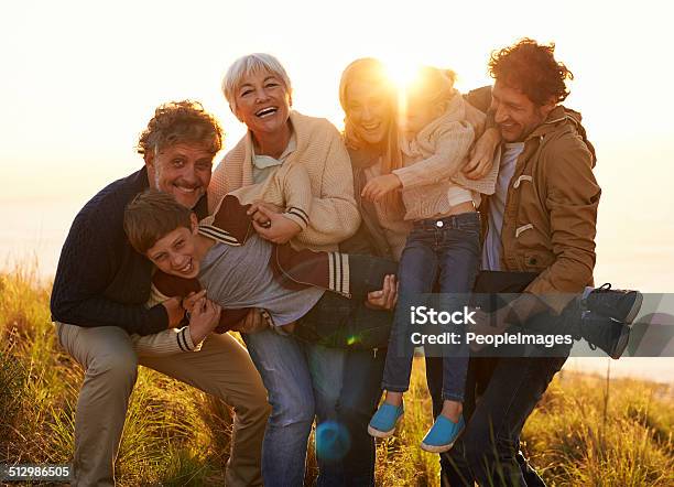 Holding Up The Family Line Stock Photo - Download Image Now - Grandfather, Teenager, Father