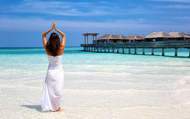 istock Woman doing yoga on a beach 512986698