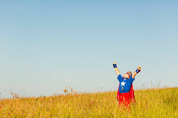 istock Young Boy Dressed as Superhero Imagines Flying 512986764