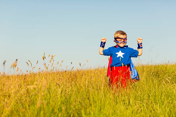 istock Young Boy Dressed as Superhero Imagines Flying 512986804