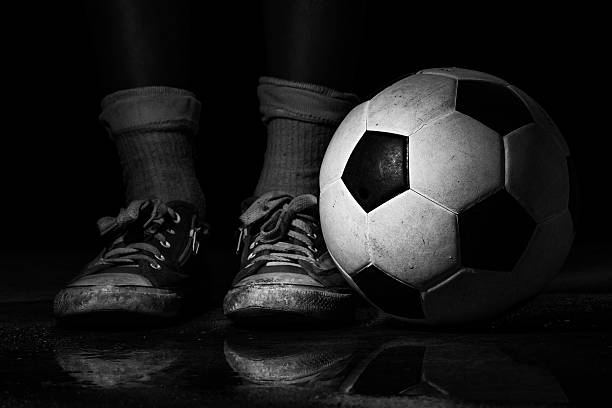 istock Black and white dirty soccer ball 512987415