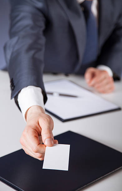 istock Man's hand reaching out a business card 512989774