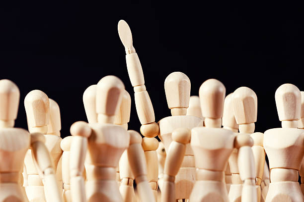 istock One member of puppet audience raises hand, volunteering or querying 512989793
