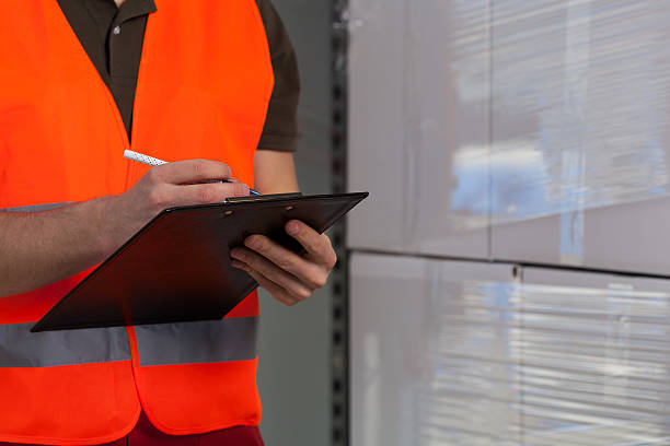 istock Close-up of a storekeeper signing document 512990163