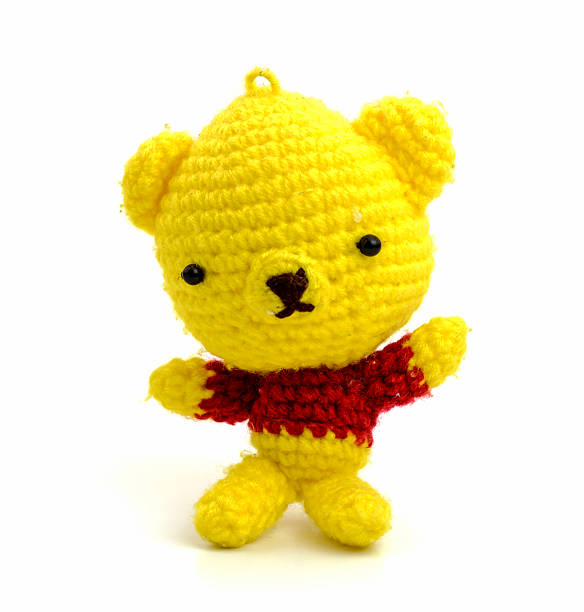 istock handmade crochet yellow bear doll on white background 512990397