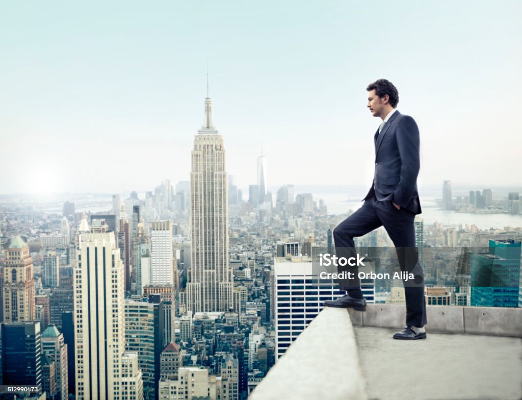 Businessman in New York City Young man looking out at Manhattan skyline New York City Stock Photo