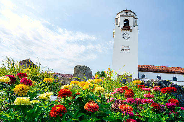 istock Train depot tower and summer flowers 512993323