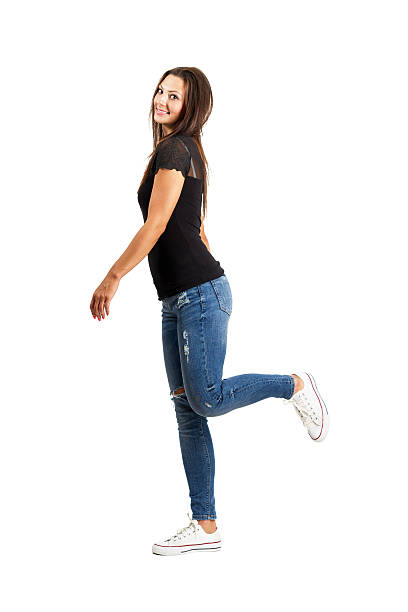istock Happy beautiful young brunette posing with raised leg 512994183