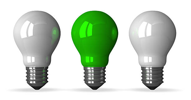 Green tungsten light bulb and two white ones, front view
