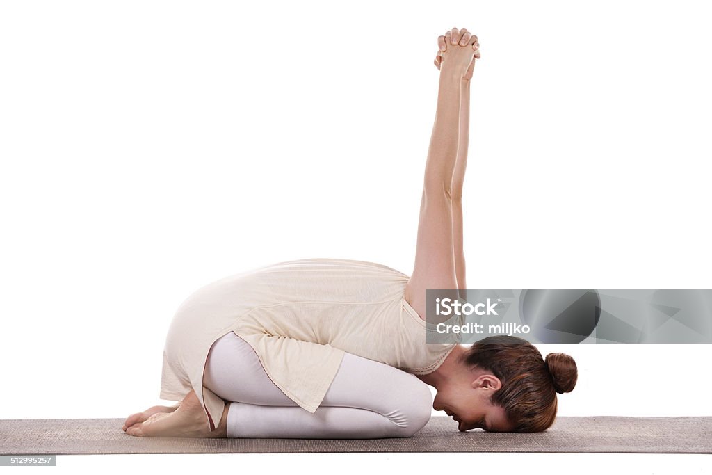 Yoga practice Mid adult woman doing yoga. Isolated on white background 30-39 Years Stock Photo