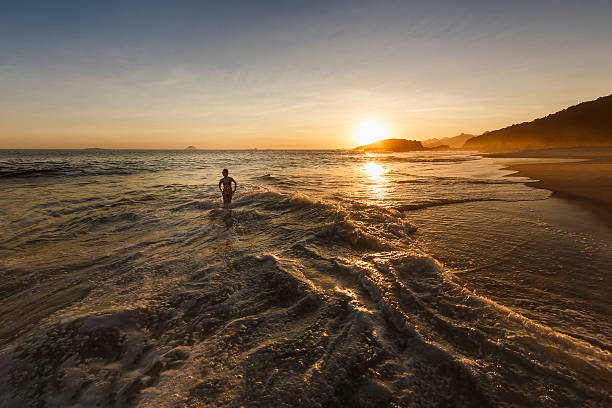 istock Little Girl Walking on the Shallows on Empty Beach 512995448