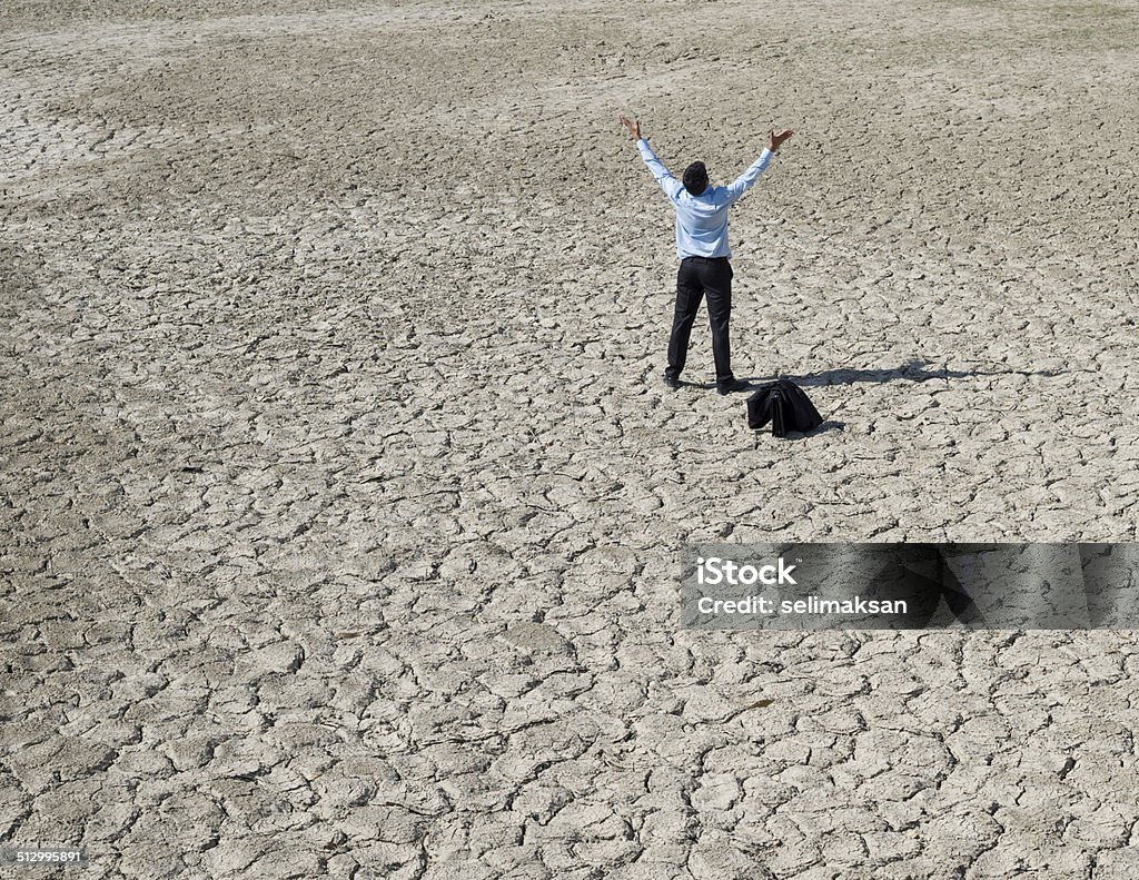 Lost businessman in desert looking for help Crisis Stock Photo