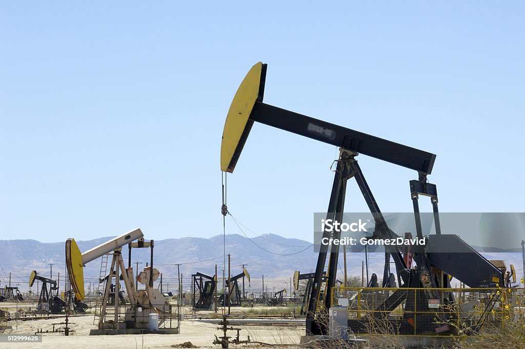 Oil Pumpjacks with Others in Background Lost Hills Oil Field pumpjack, with others in background. Borehole Stock Photo