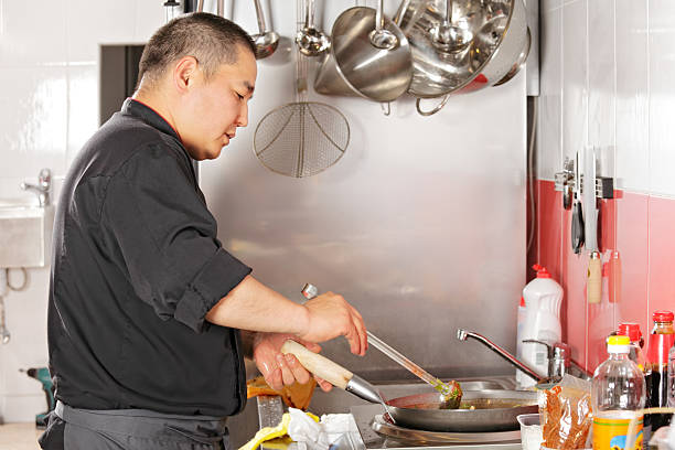 istock Chef cooking food in wok pan 513000903