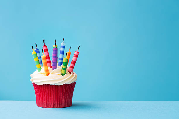 istock Birthday cupcake with candles blown out 513001099