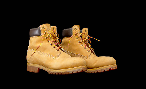 Authentic pair of 8 inch Timberland Yellow Work Boots Tel Aviv, Israel - September 13, 2014: Authentic pair of 8 inch Timberland Yellow Work Boots isolated on black (illustrative editorial) timberland arizona stock pictures, royalty-free photos & images