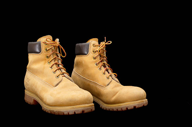 Authentic pair of 8 inch Timberland Yellow Work Boots Tel Aviv, Israel - September 13, 2014: Authentic pair of 8 inch Timberland Yellow Work Boots isolated on black (illustrative editorial) timberland arizona stock pictures, royalty-free photos & images