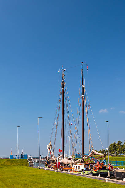 Stavoren, The Netherlands - September 4, 2014: Classic wooden sailing boat waiting in a sluice in the Stavoren harbor in the province of Friesland, The Netherlands
