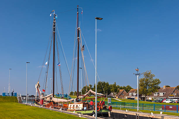 Stavoren, The Netherlands - September 4, 2014: Classic wooden sailing boat waiting in a sluice in the Stavoren harbor in the province of Friesland, The Netherlands