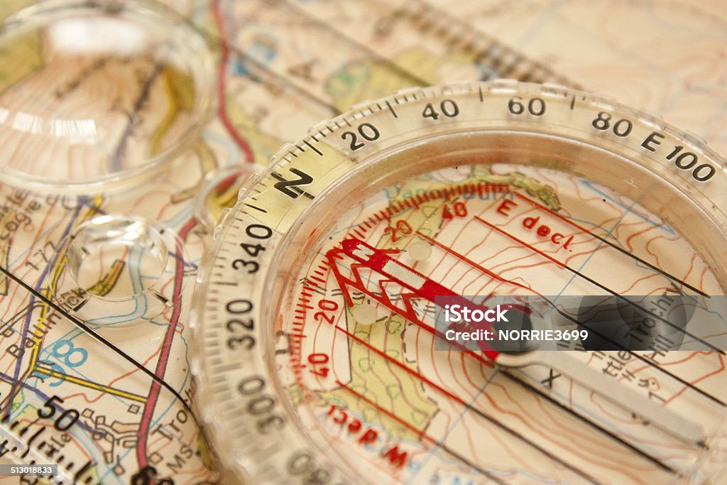 North Direction A compass laying on an OS map with the needle pointing directly North. Cartography Stock Photo