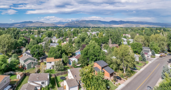 aerial panorama of residential area in Fort Collins, Colorado, with foothills of Rocky Mountains and Horsetooth Rock in background, late summer
