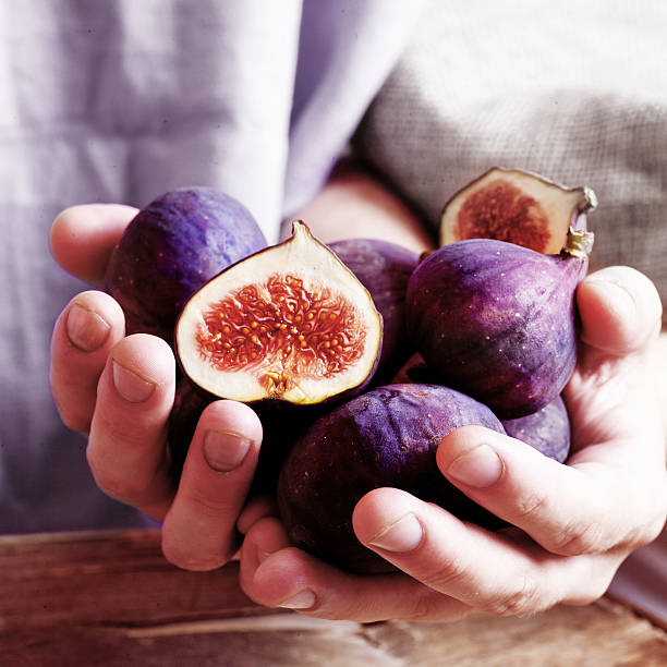 istock juicy figs in the hands 513021389
