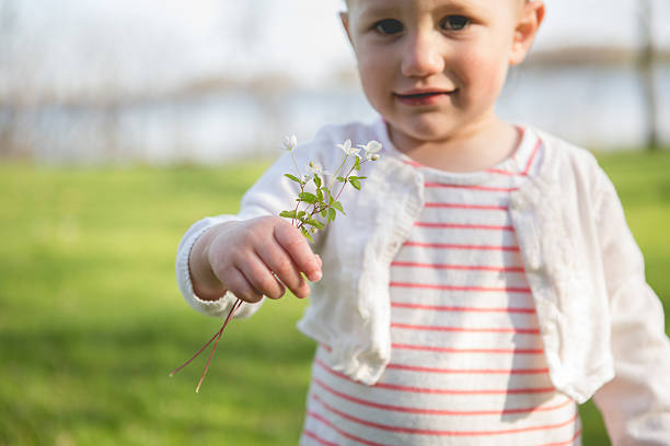 istock Little girl with flowers 513022221