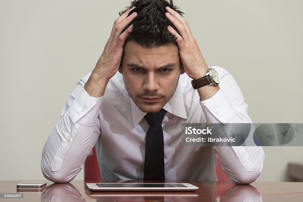 Overworked Businessman Sitting By His Desk Young Business Man With Problems And Stress In The Office Adult Stock Photo
