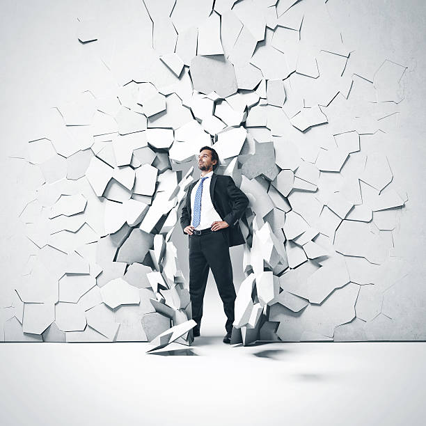 istock Young businessman breaking trough a wall 513024703