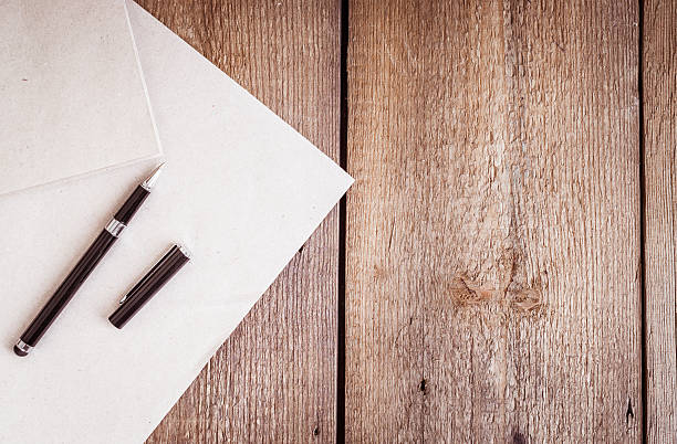 istock Paper and pen on wooden background 513042030